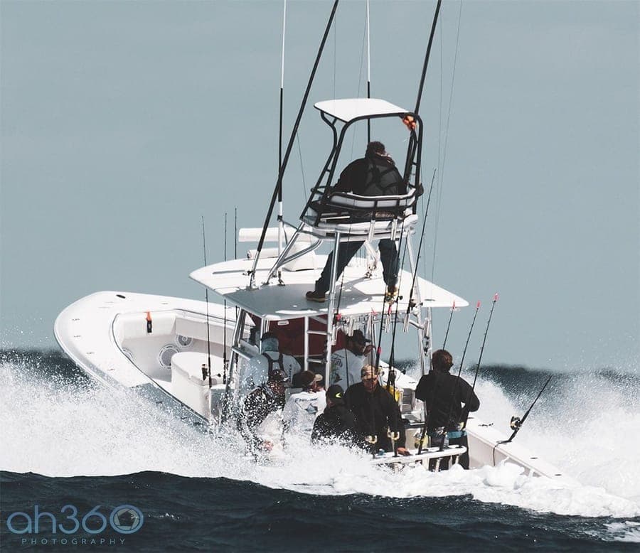 Contender center console fishing boat running through ocean waves off Florida