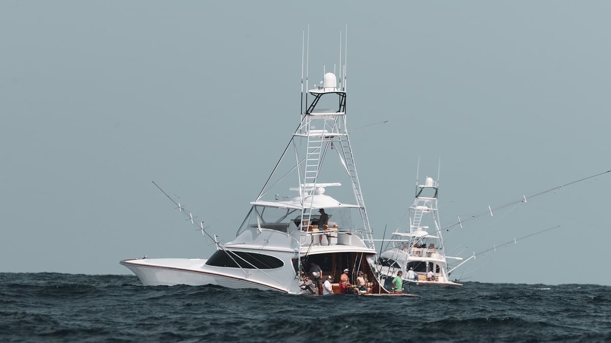 Two sportfishing boats navigating choppy waters, equipped with tall towers and fishing gear
