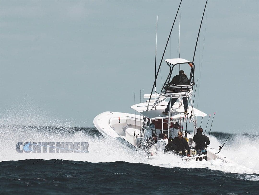 Sportfishing boat speeding through waves with anglers onboard, showcasing powerful engines and multiple fishing rods