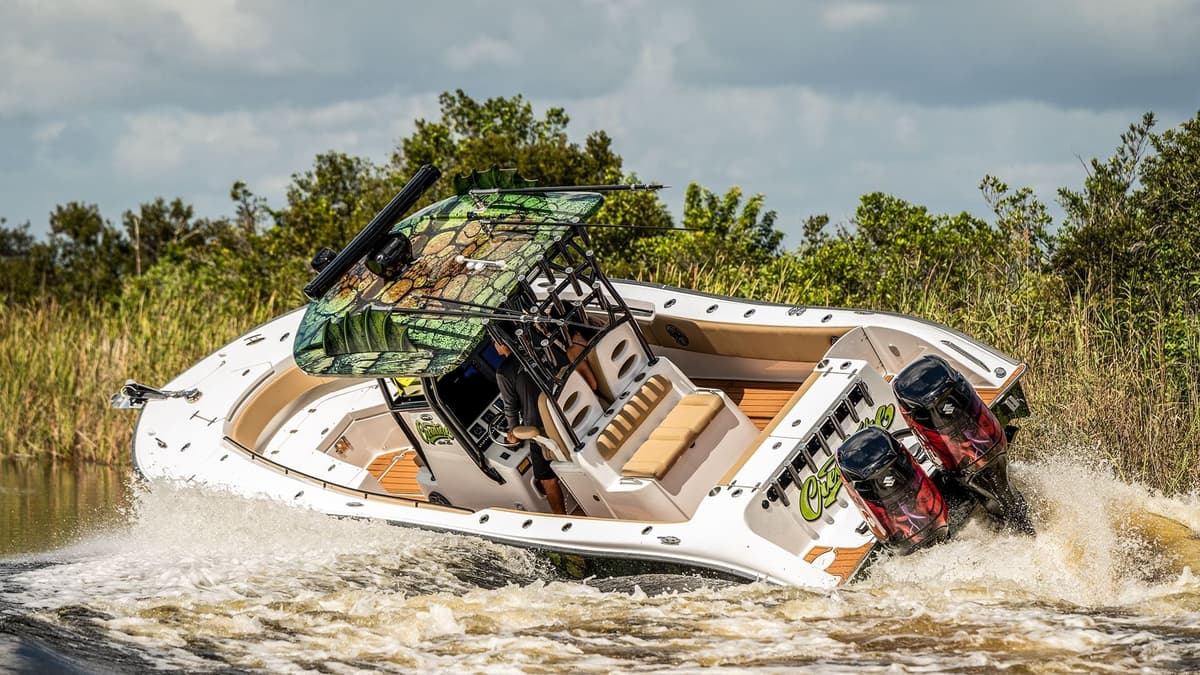 High-performance sportfishing boat navigating through water with twin engines and a customized camo canopy