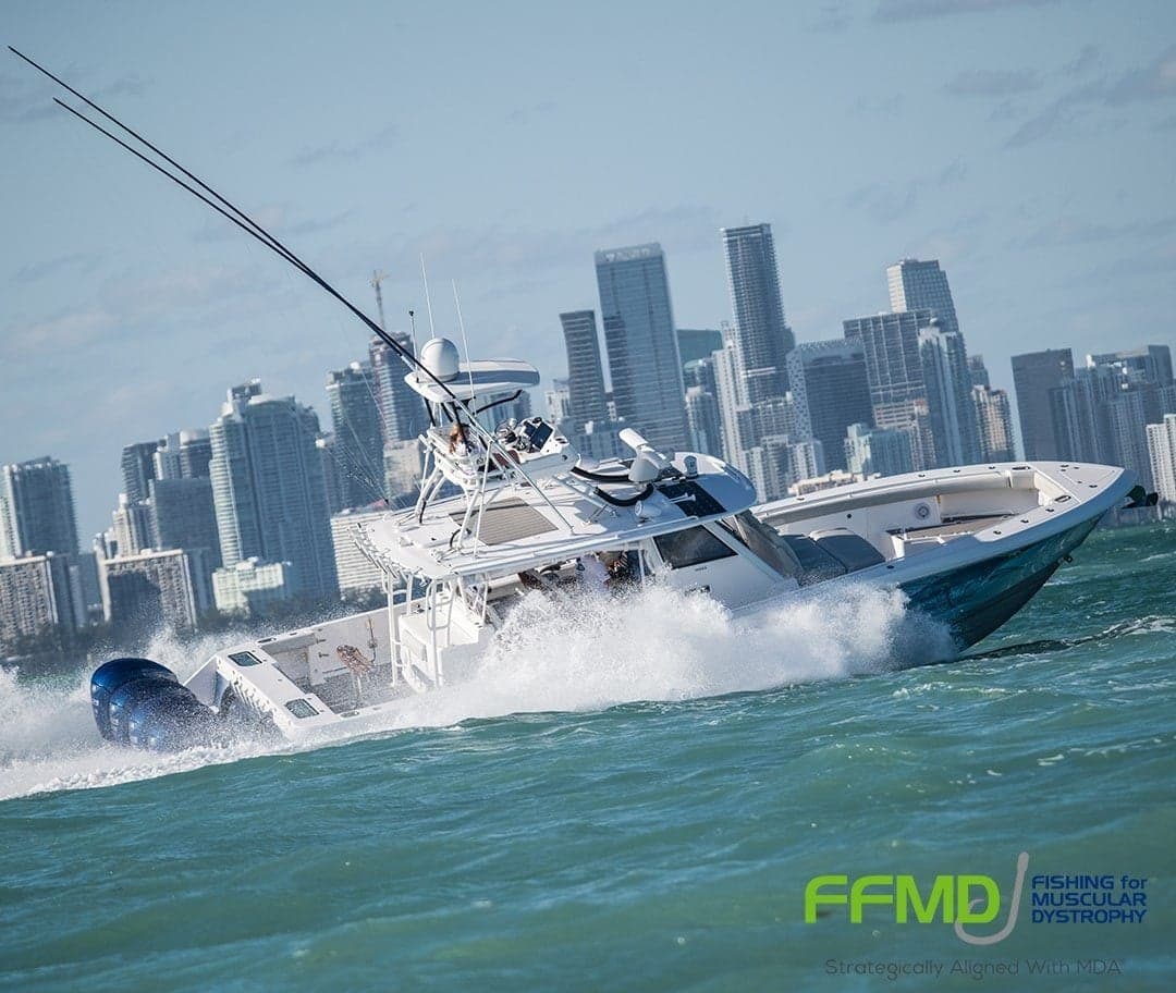 Dynamic sportfishing boat navigating through choppy waters, framed by a bustling city skyline