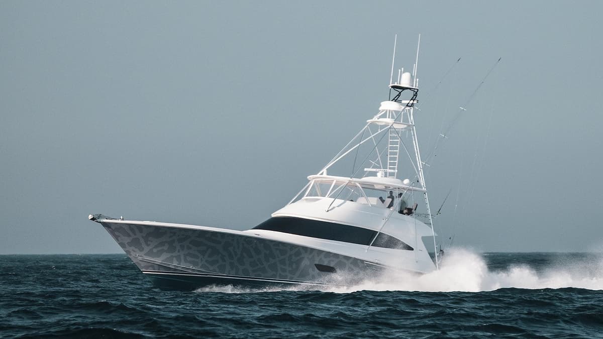 A powerful sportfishing yacht cutting through the ocean waters, showcasing its robust design and elegant lines