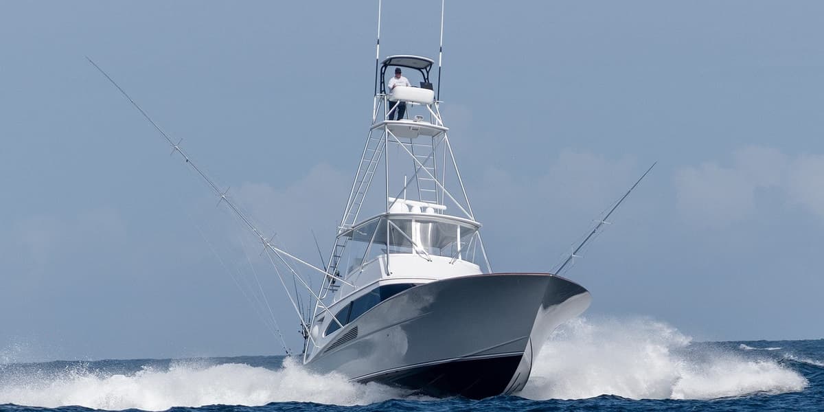 Dynamic image of a sleek sportfishing boat with a high tuna tower gliding through the ocean