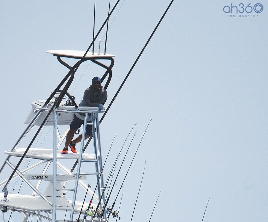 Close-up of a person perched on a sportfishing boat during a tournament