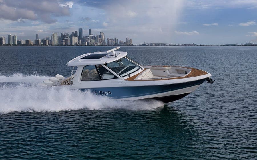 Day boat running past the Miami skyline and a causeway bridge near Miami Beach Marina — brokerage listing photography