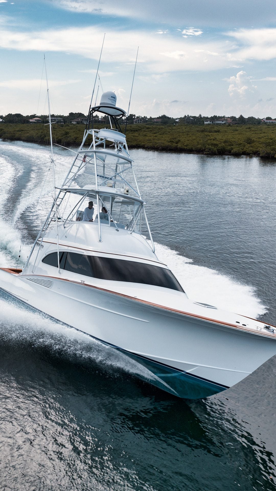 Sportfishing yacht cutting through the water photographed from above by AH360 drone