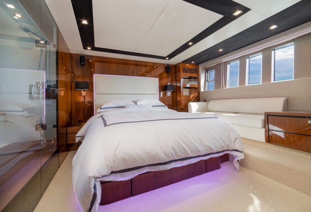 Professional yacht interior photography of master stateroom showing balanced window exposure, rich wood tones, and detailed textures using HDR photo blending technique in Fort Lauderdale