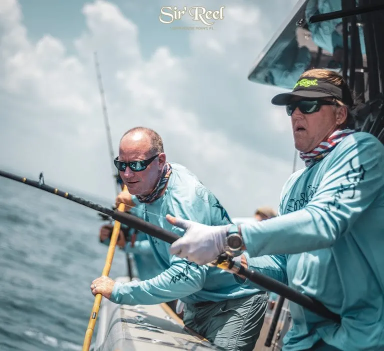 Captain Skip Dana Gaffing A Kingifish on Sir'Reel Fishing Team